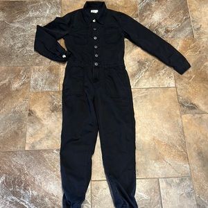 Utility jumpsuit. Button front with zip fly. Button cuffs and back pockets